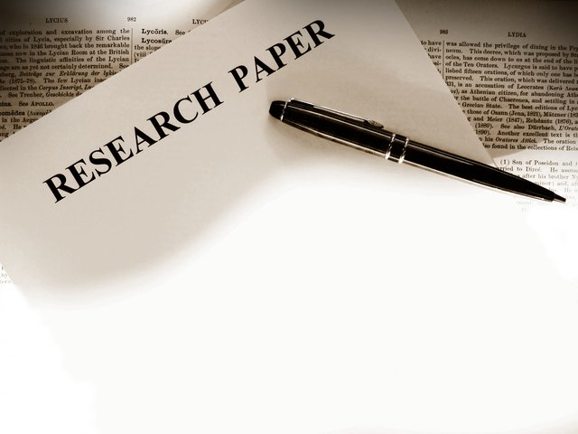 What is the first step in writing a research paper