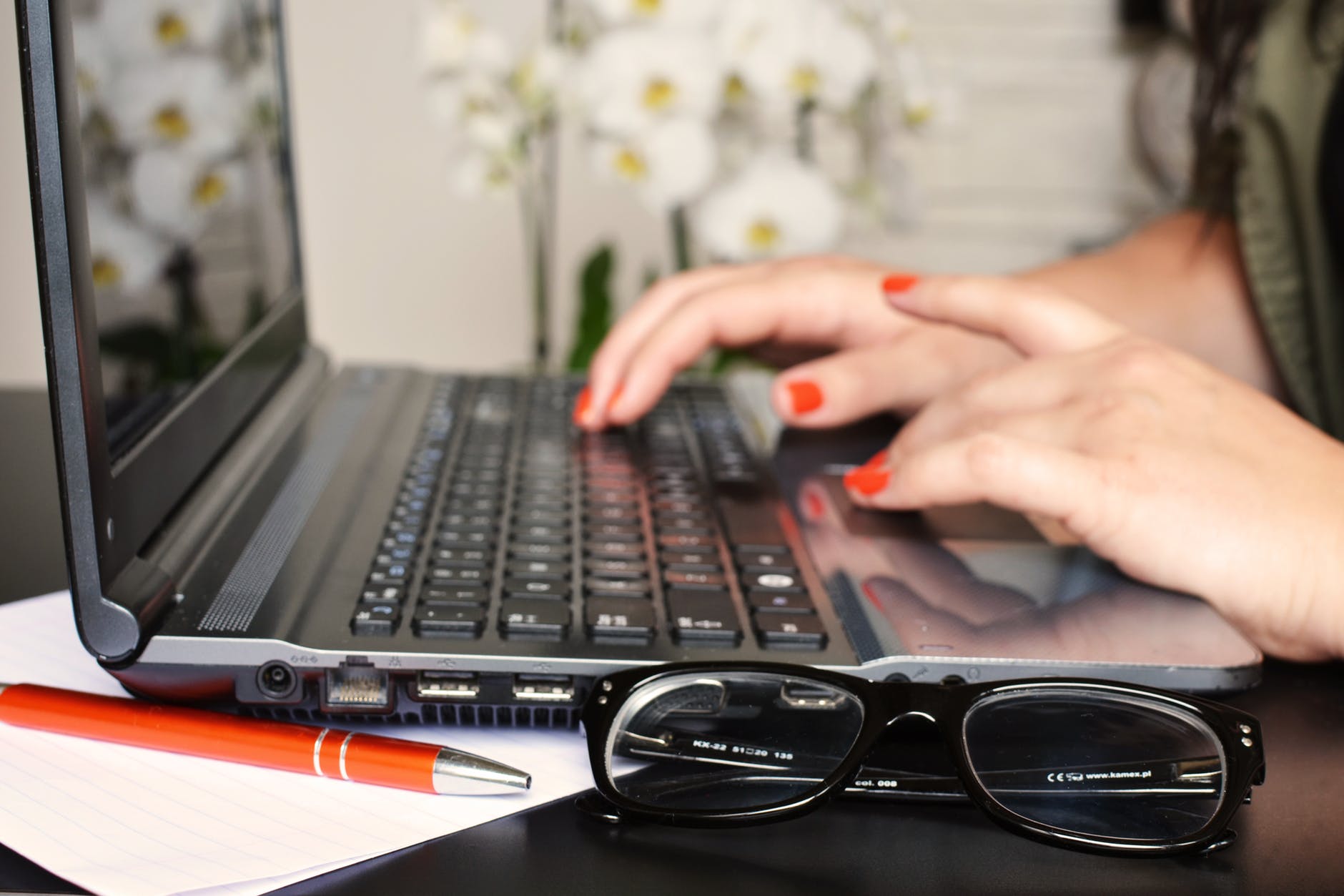 a woman typing on a laptop