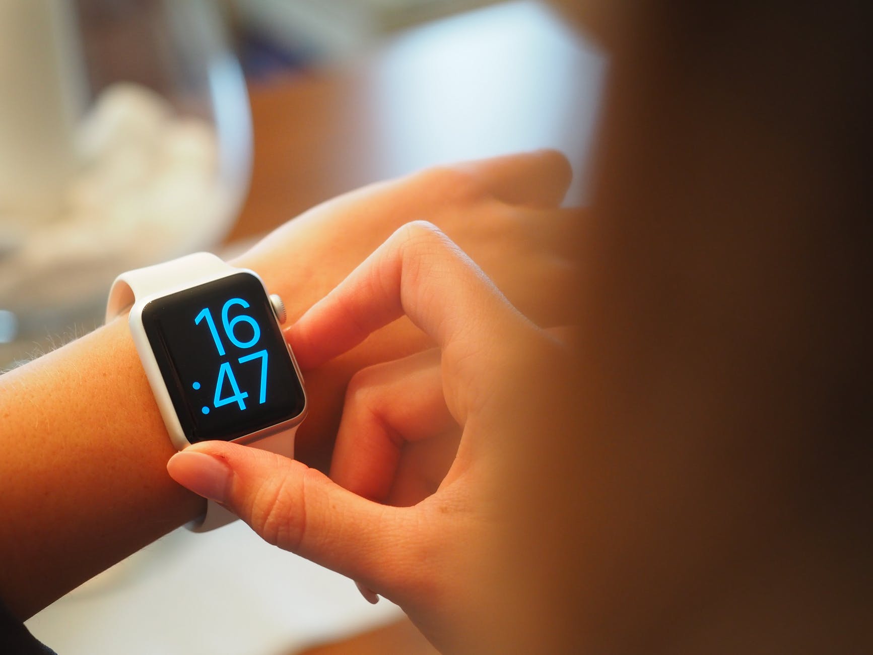 a girl is checking her wrist watch