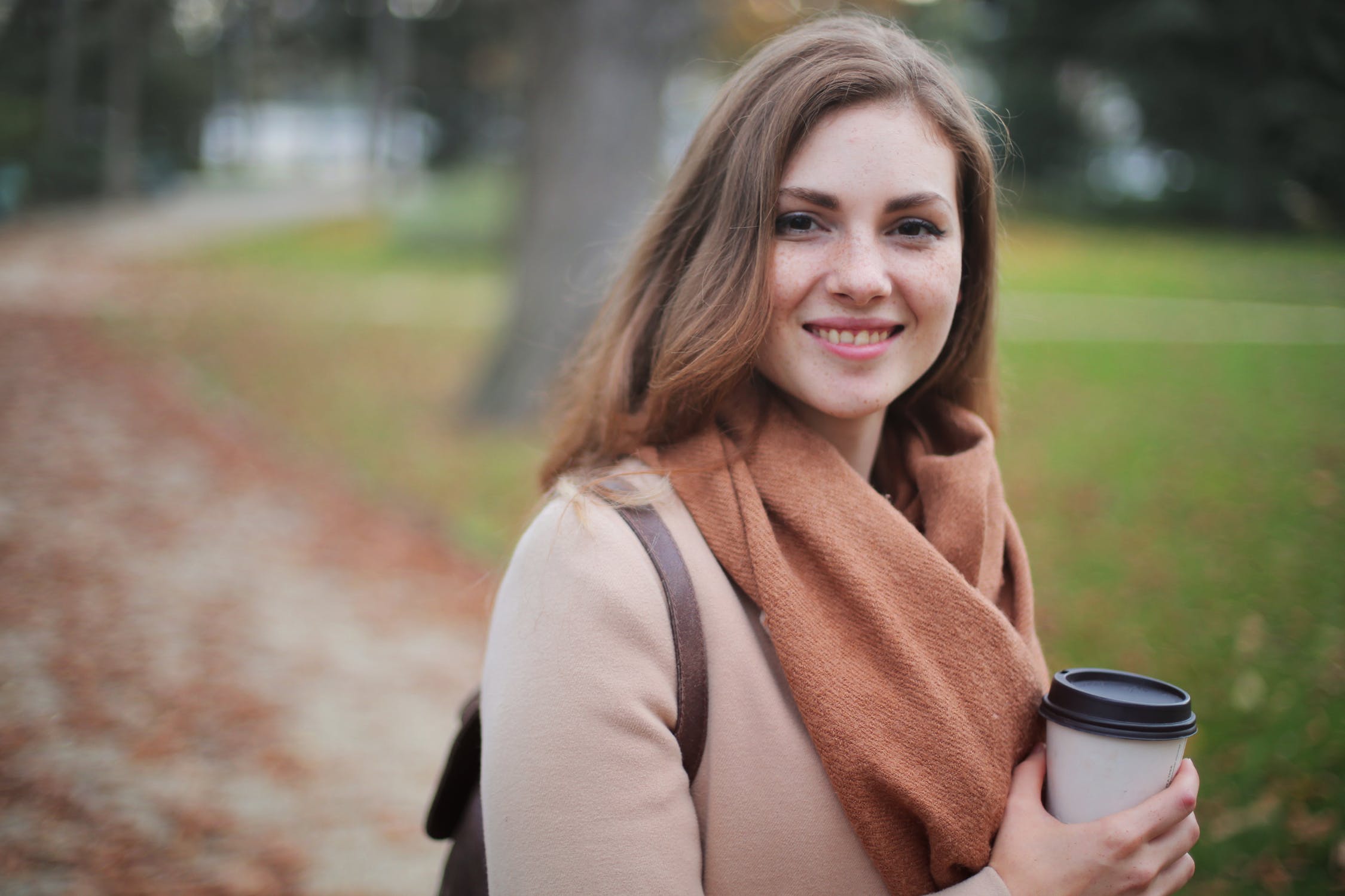 a girl in a scarf with a cup of coffee