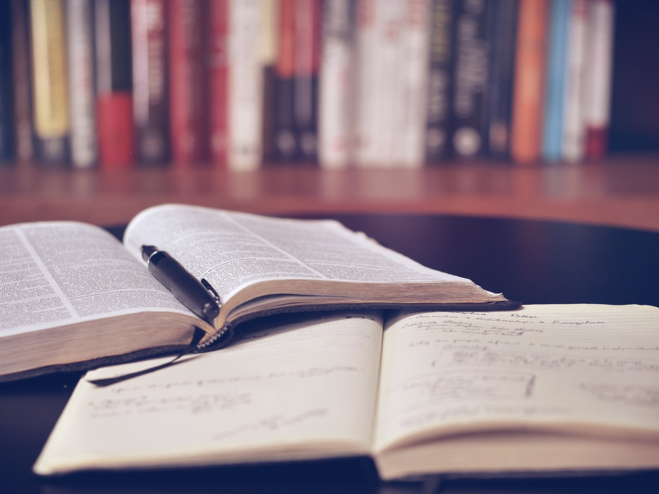 a book and a notebook on the table