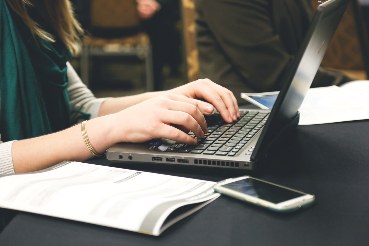 a woman typing on her laptop