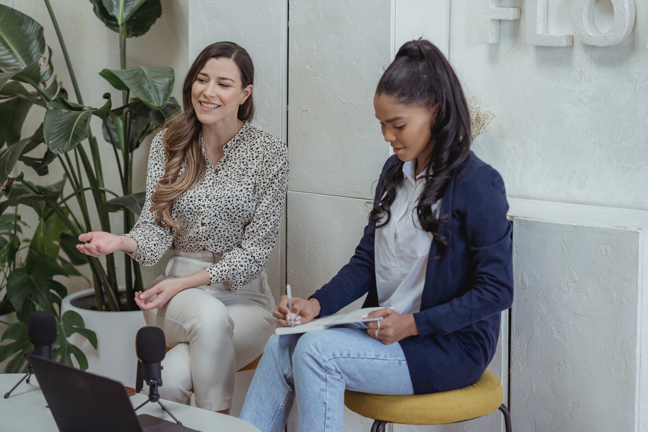 two girls are sitting next to each other