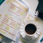 a cup of coffe and working sheet