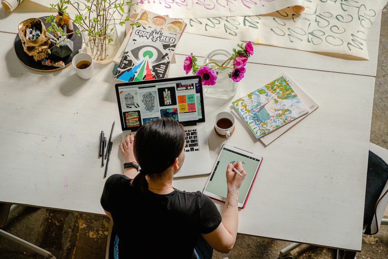 a girl with a laptop and art supplies