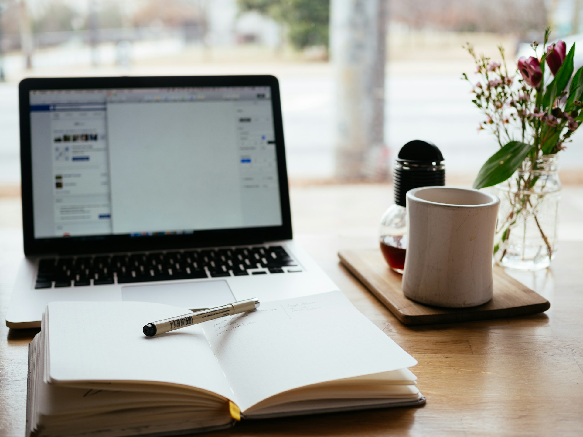 a desk with notes and laptop