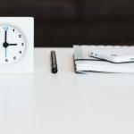 a clock and papers